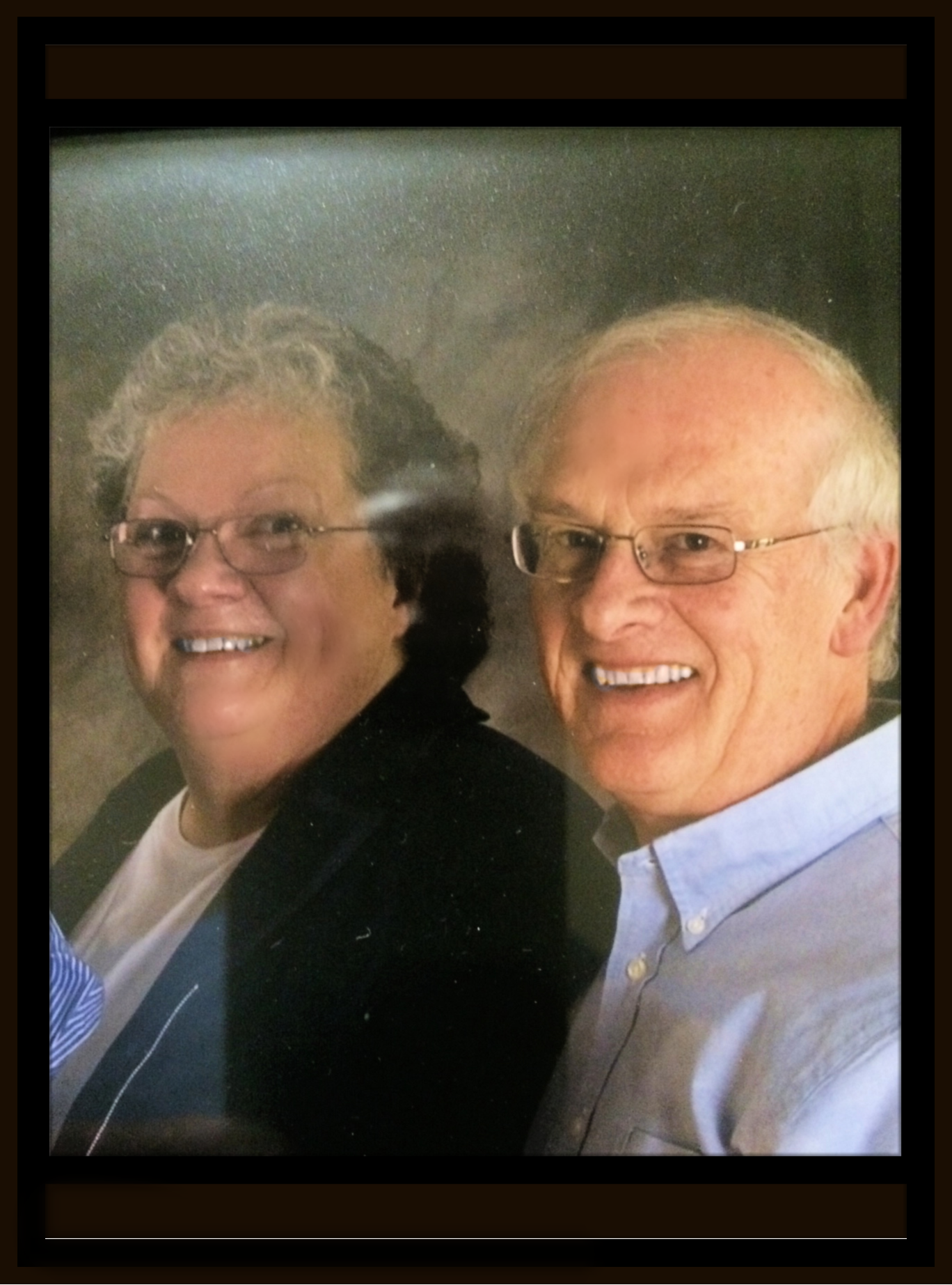 Elderly woman and man smiling close to each other