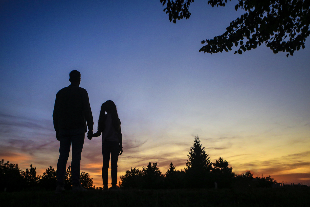 Silhouette of a two generation family - single fasther and his daughter.