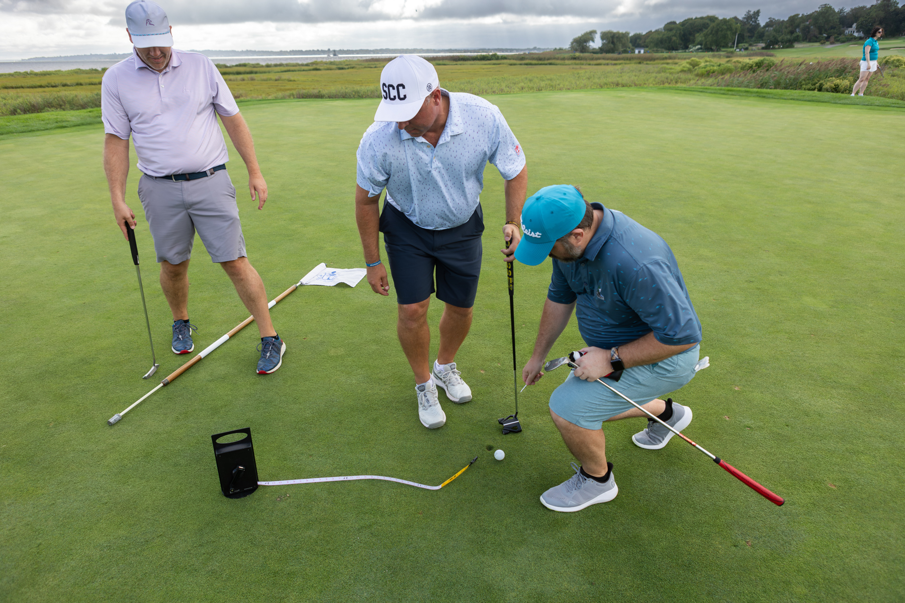 Golfers measuring distance to hole