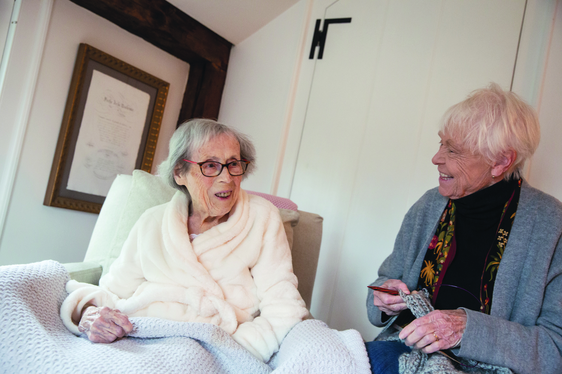 volunteer smiling with an elderly patient