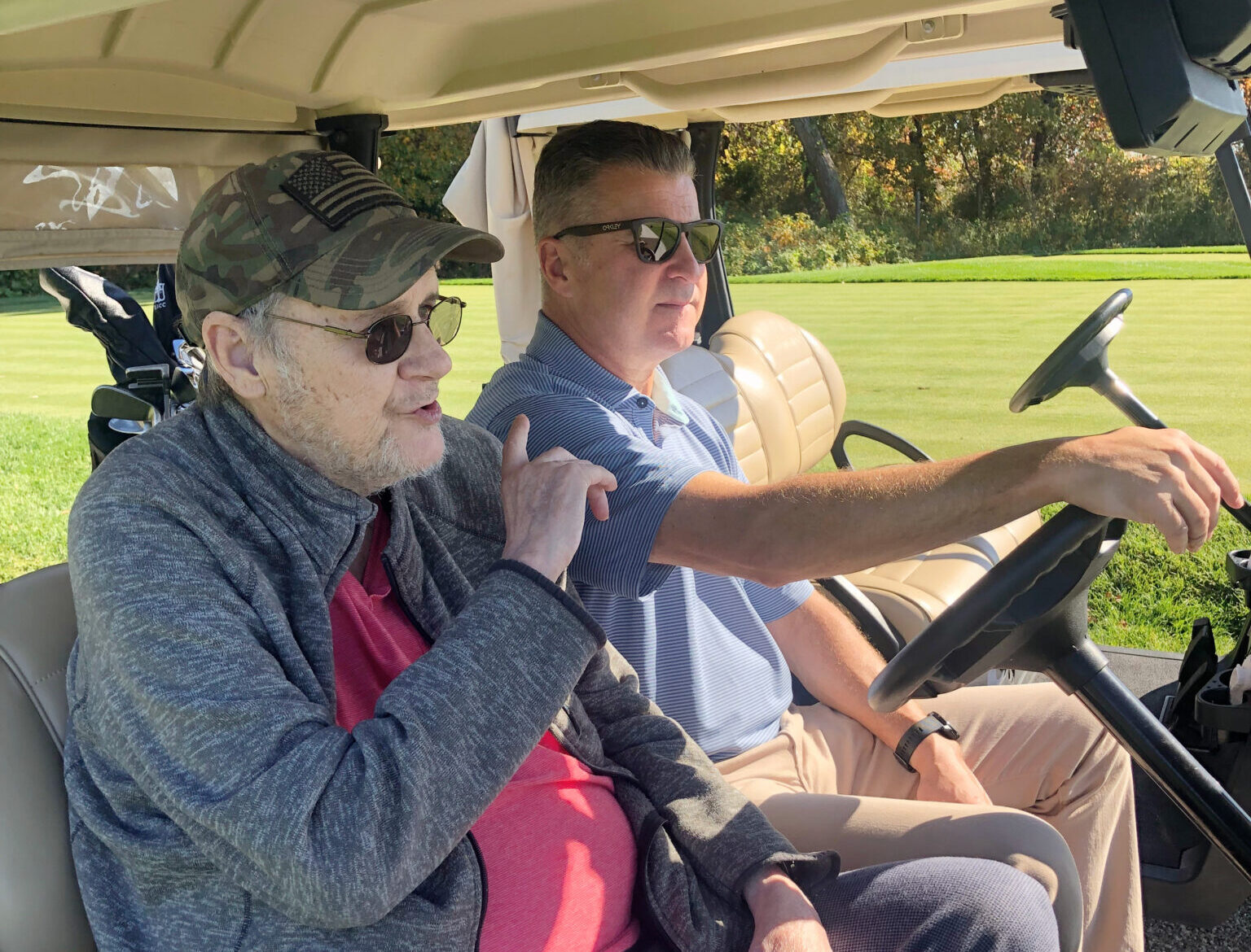 Two men in golf cart