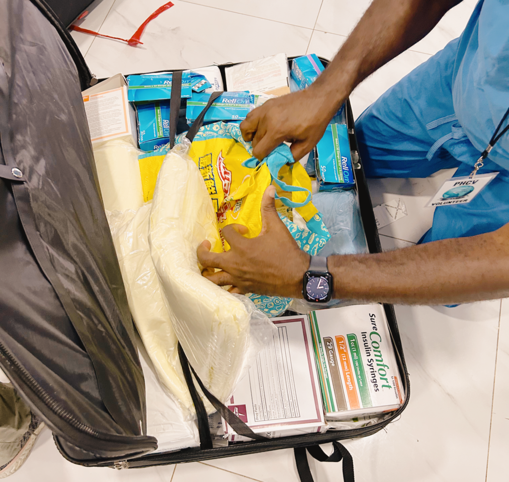 man reaching into a medical bag full of medical supplies