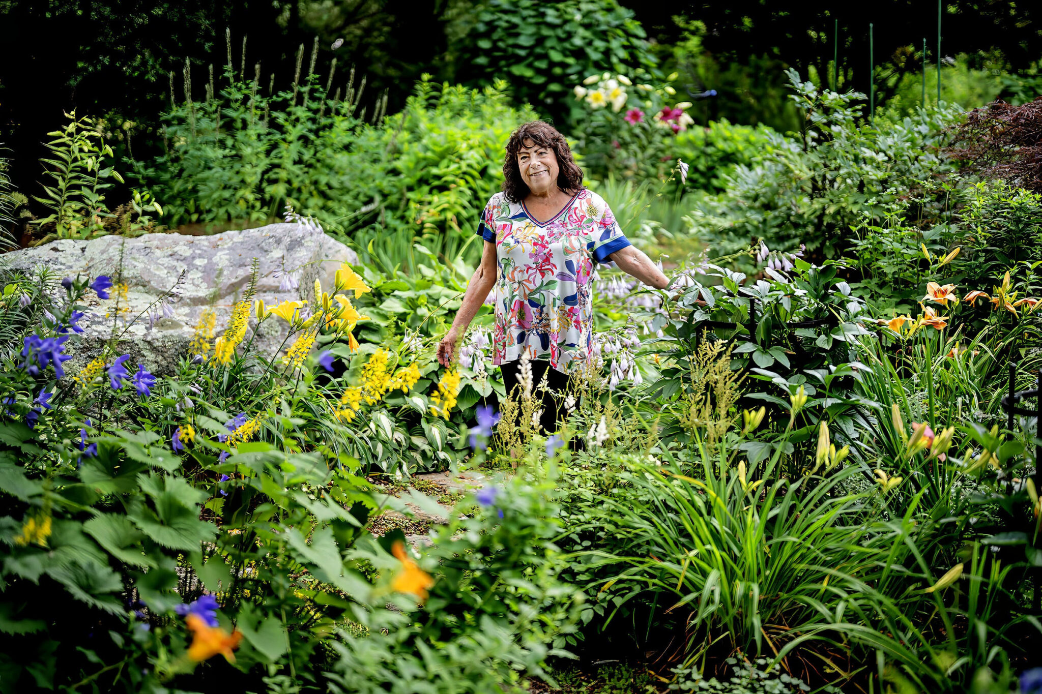 Woman standing amongst her garden