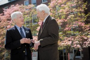 Dr. Edward Martin, HopeHealth Chief Medical Officer, stands to the left of Dr. Stanley Aronson, early founder of HopeHealth in front of cherry blossoms