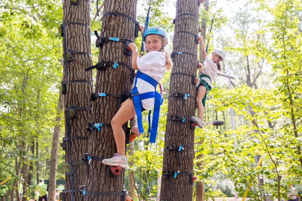 Girl climbing a tree at Camp BraveHeart