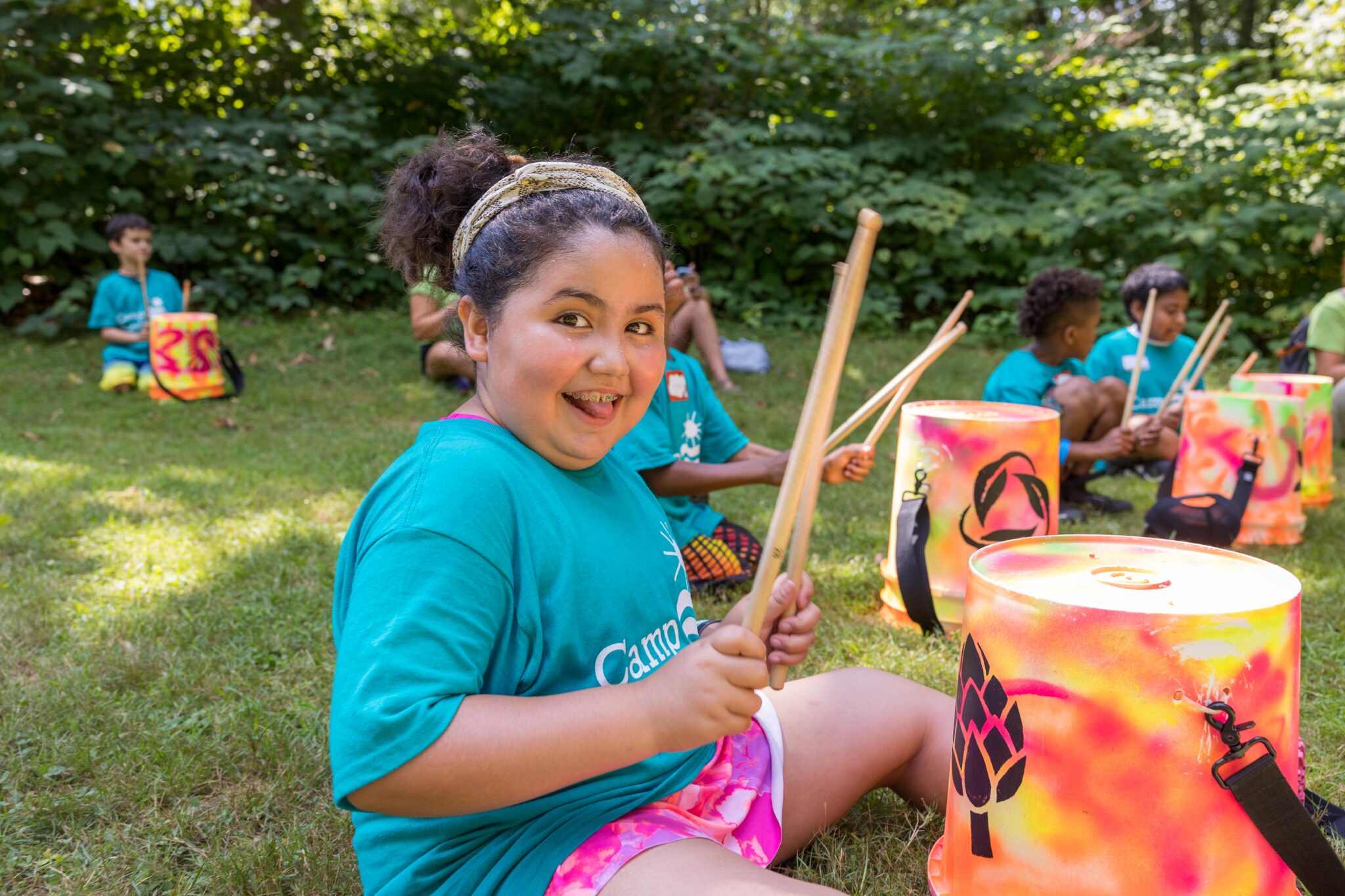 Girl gets ready to play drums at Camp BraveHeart
