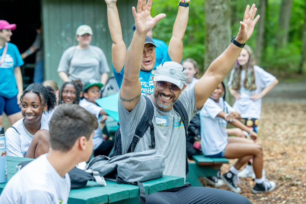 Campers raising their hands