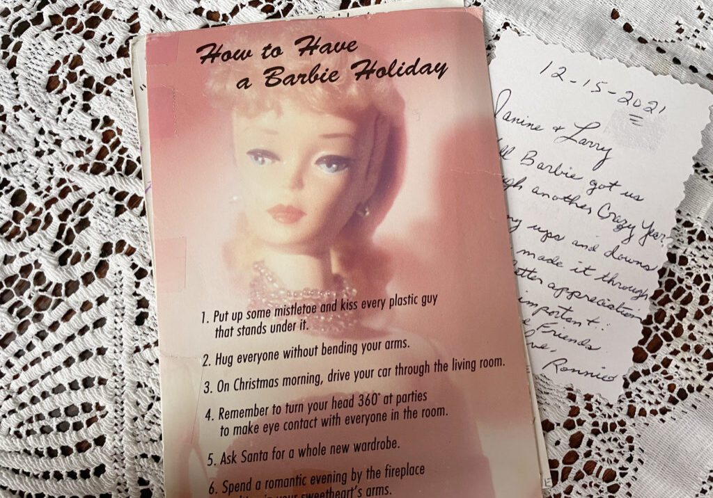 Card with photo of vintage Barbie doll on cover and handwritten note over lace tablecloth