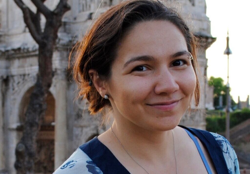 Gabi Headshot Rome Woman standing in front of a church in Rome