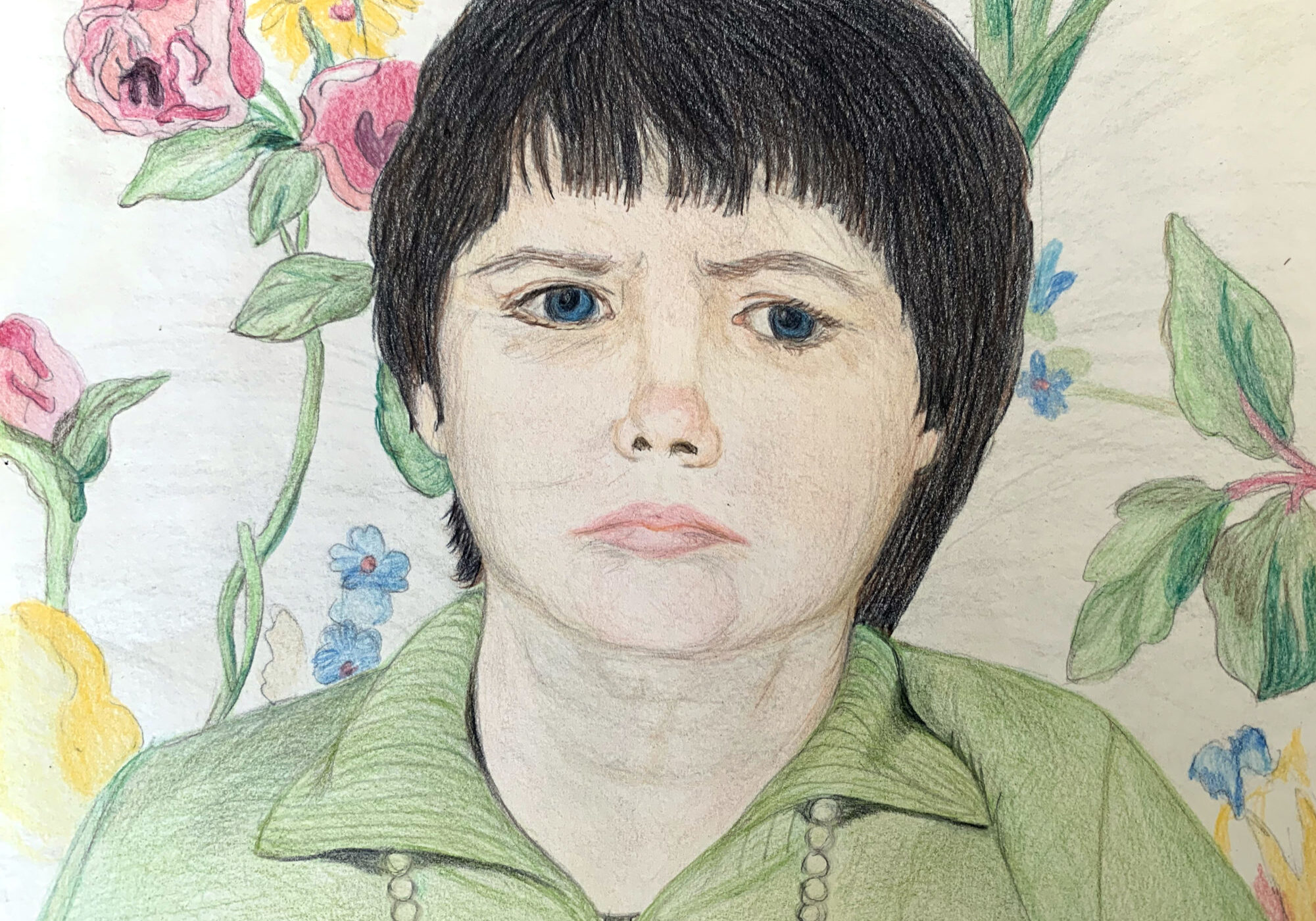 Colored pencil drawing of woman with dark hair and blue eyes wearing green shirt against floral chair