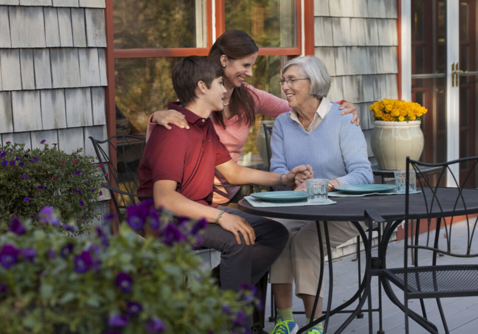 Grandma enjoying a meal with her daughter and grandson.