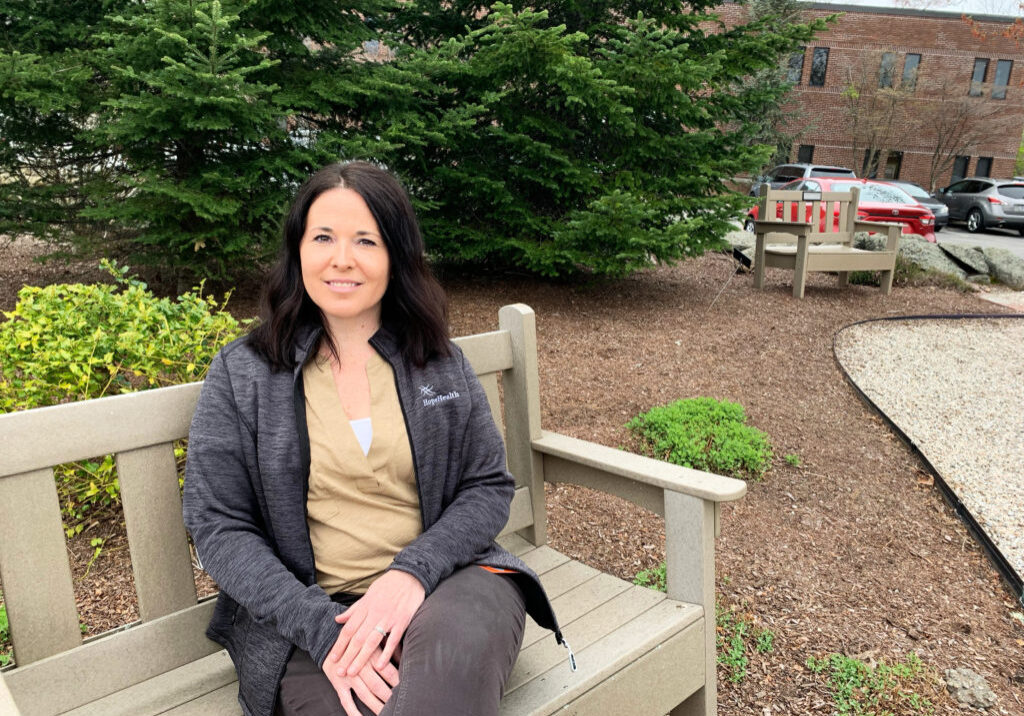 Home care cardiac nurse sits on a park bench
