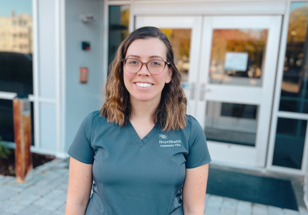 IMG_0835.heic Physical therapist in gray scrubs stands in front of a building