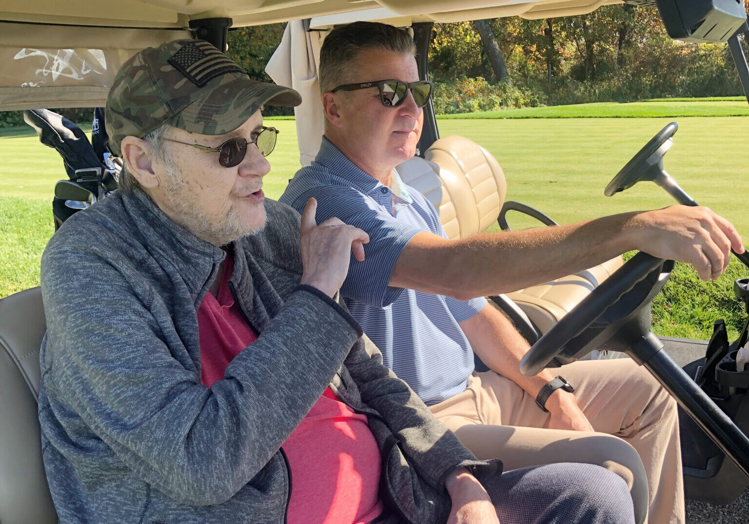 Two men in golf cart