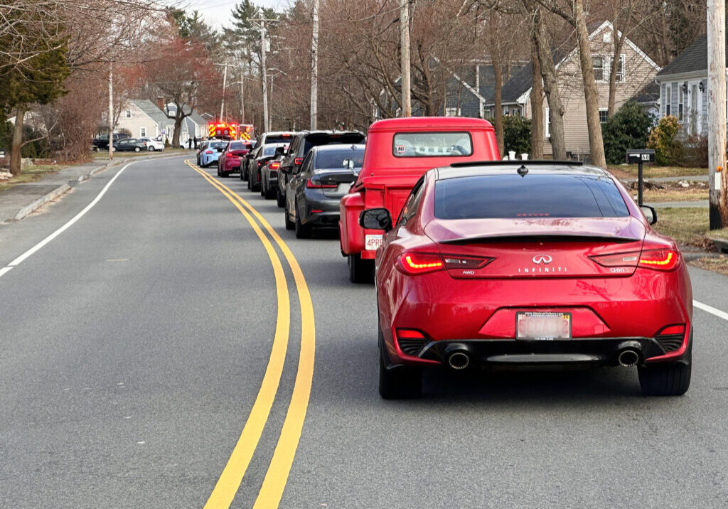IMG_5427.heic A row of cars lines up along the road to surprise a pediatric hospice patient