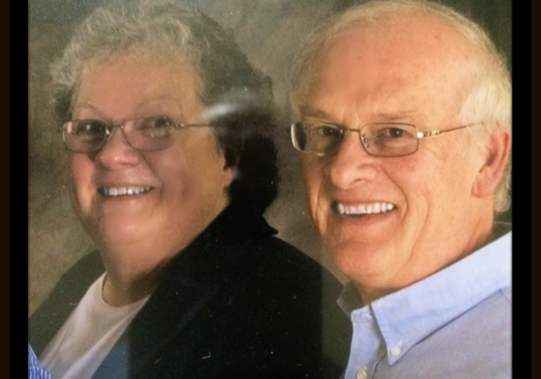 Elderly woman and man smiling close to each other