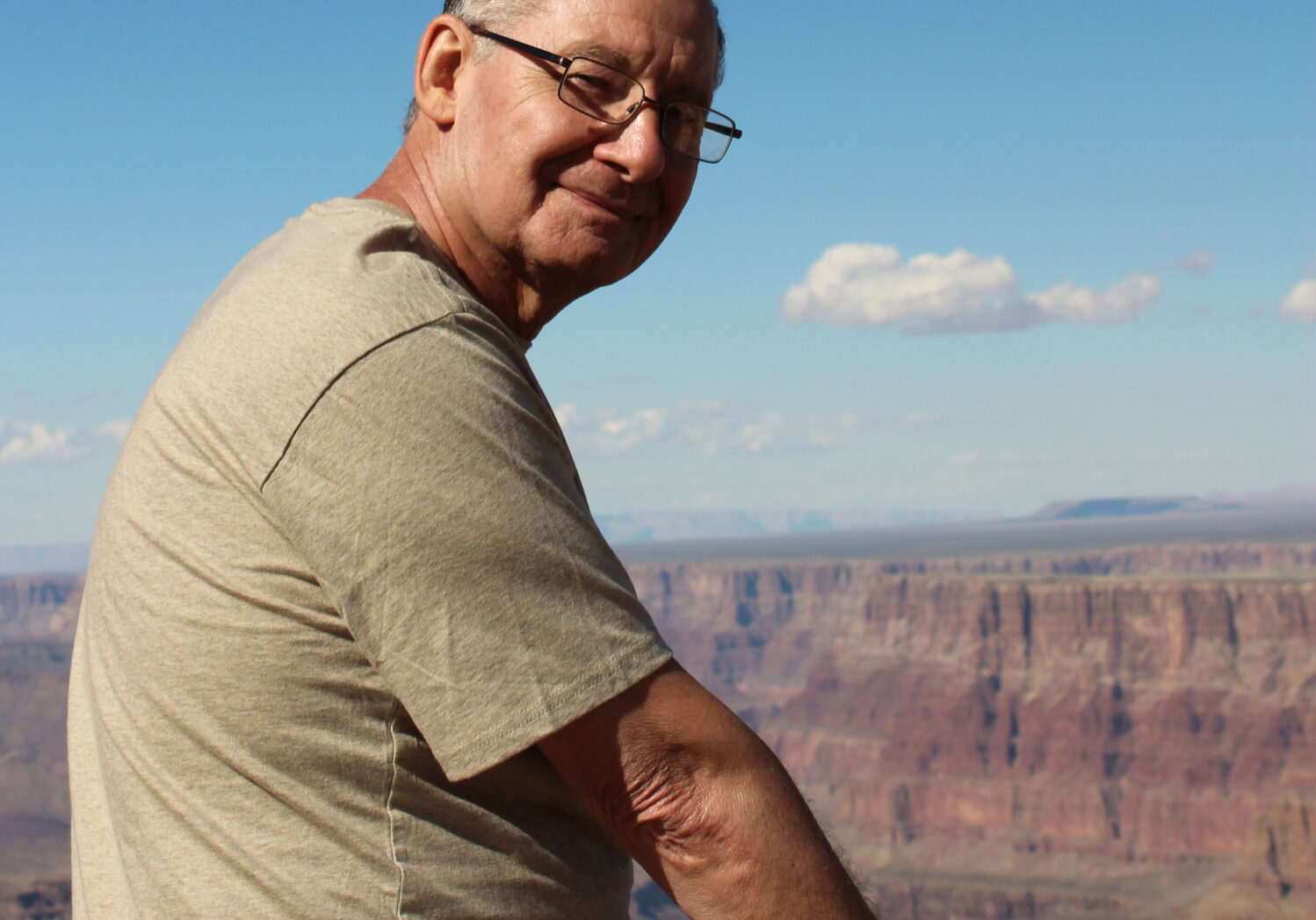 man staring back from a view of the Grand Canyon