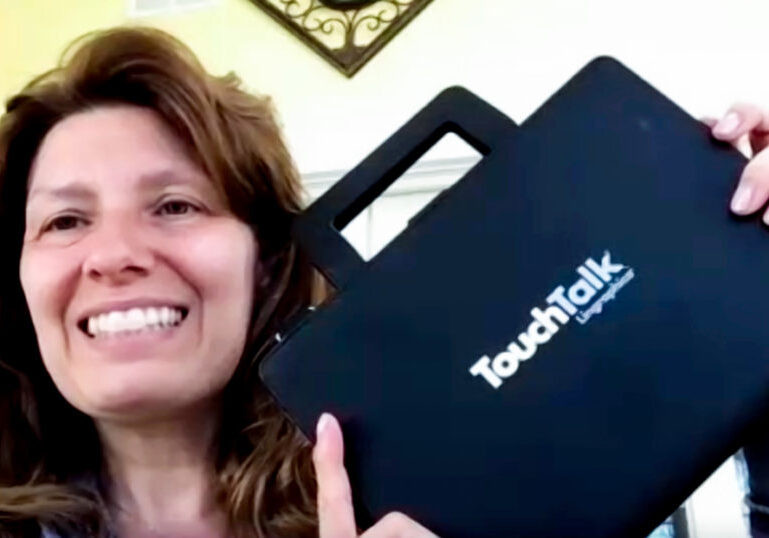 Female HopeHealth Speech Language Pathologist Joni Hodges holds up one of her favorite tools, an augmentative and alternative communication device from Lingraphica. The tablet makes it easy for people with a wide range of abilities to communicate in several ways.