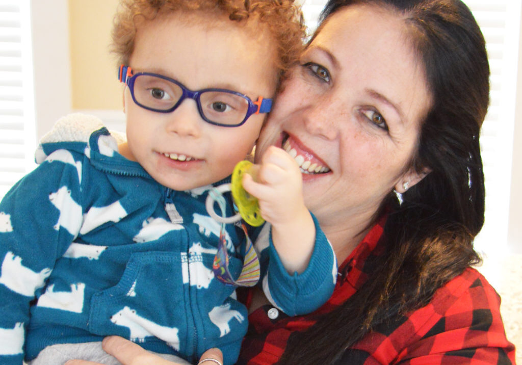 Juliana Oliveira holds her son Josue Oliveira. She is happy to see him doing well with pediatric palliative care
