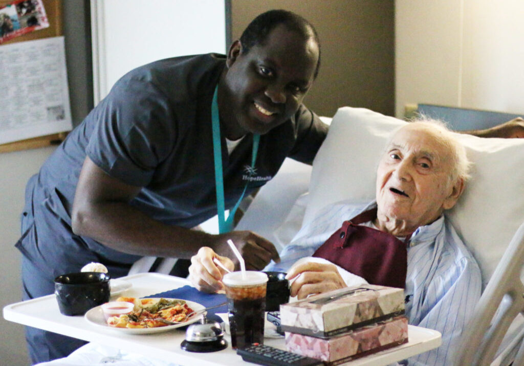 Young man standing with geriatric patient