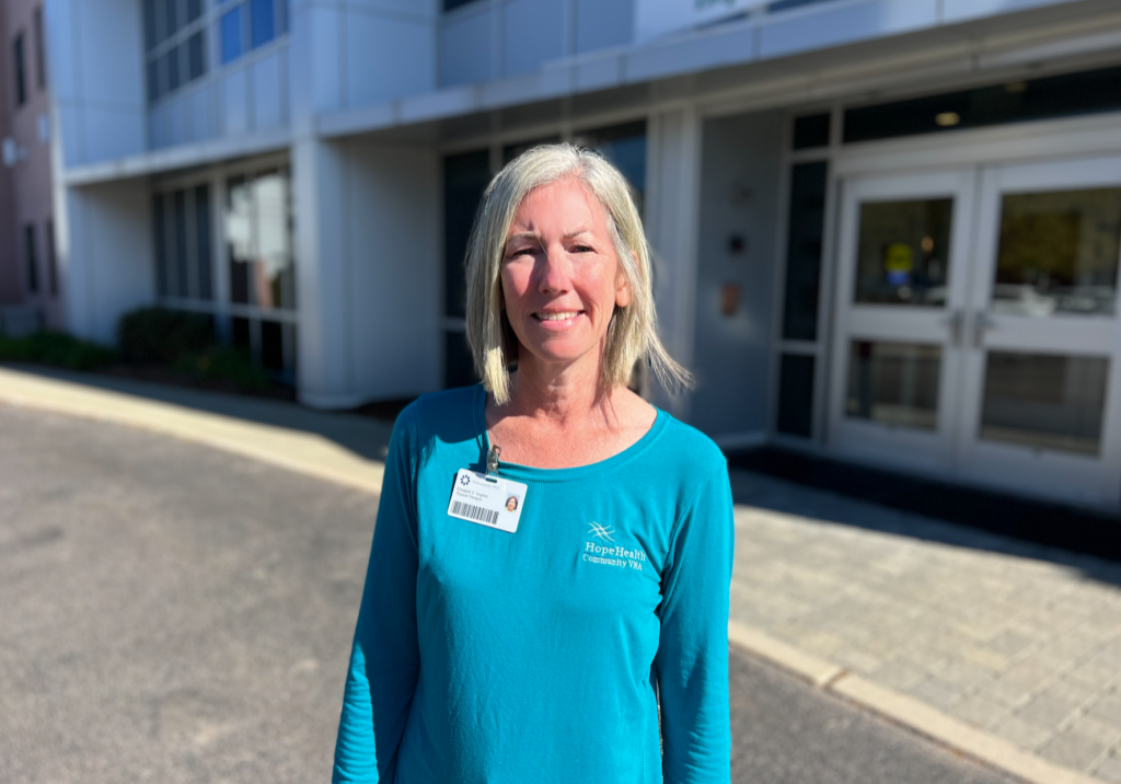 Physical therapist standing in front of an office building