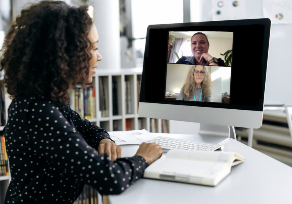 Woman sitting at her desk with a computer screen in front of her. She's partaking in a virtual grief support group