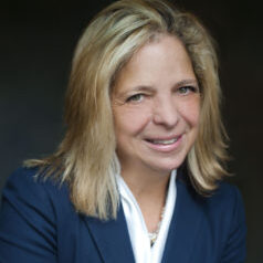 Blond professional in navy blue suit jacket and white dress shirt