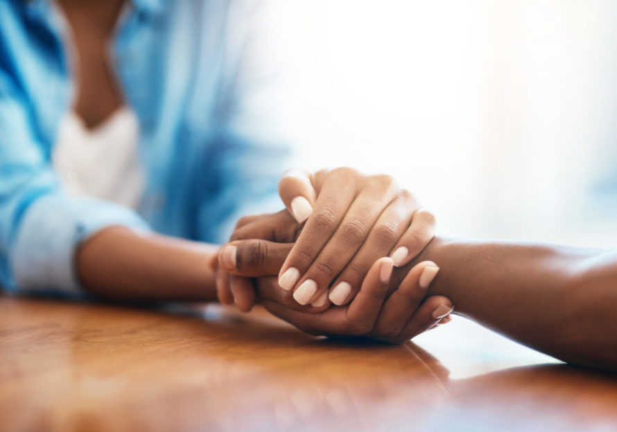 You have my full support Hospice aide holding her patients hand