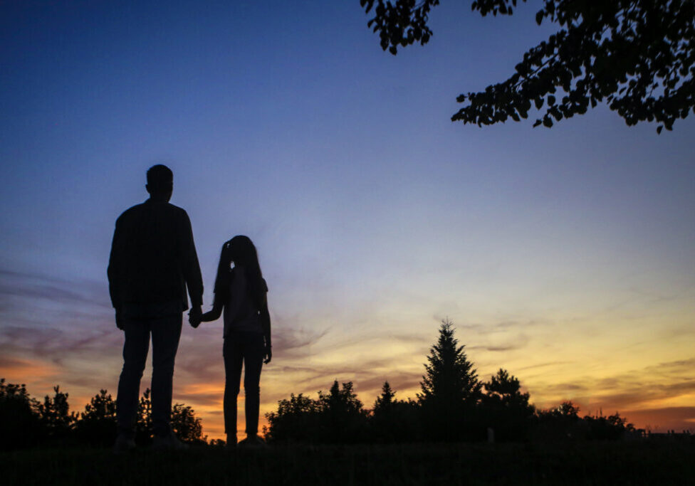 Silhouette of a two generation family - single fasther and his daughter.