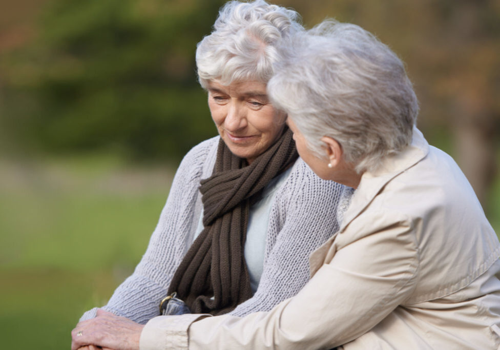 Cropped view of a senior woman caring for her friend