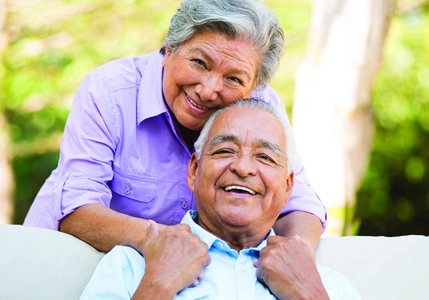 A senior couple holding hands.