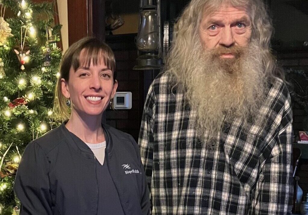 Man standing with nurse in front of Christmas tree